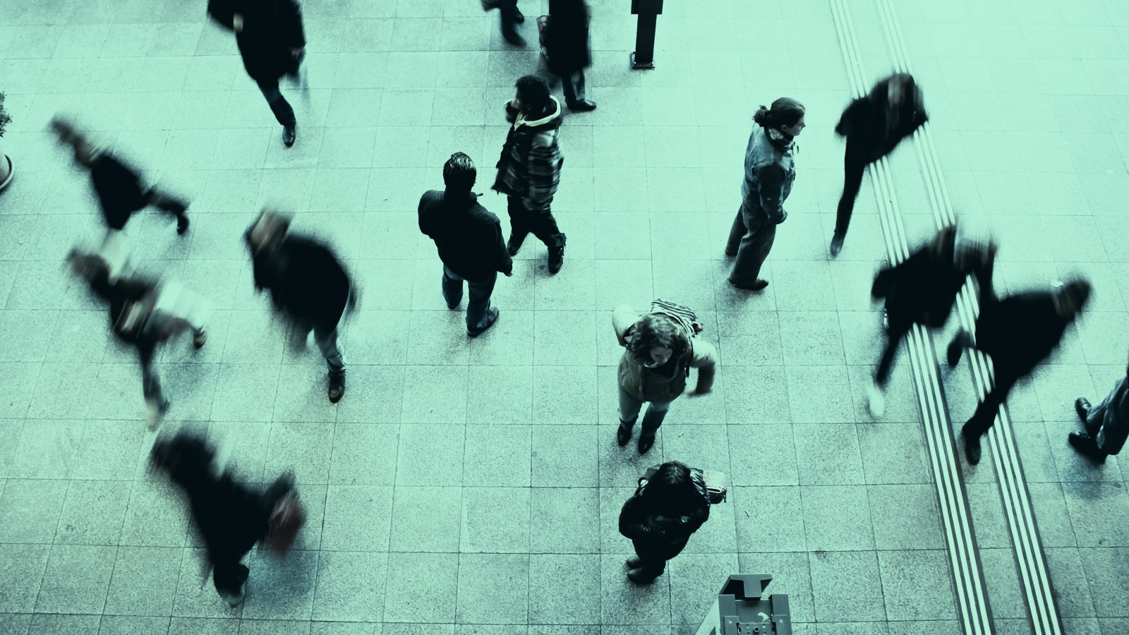 AI candidate screening cover, a blurred crowd crossing a concourse at pace, Axial Search