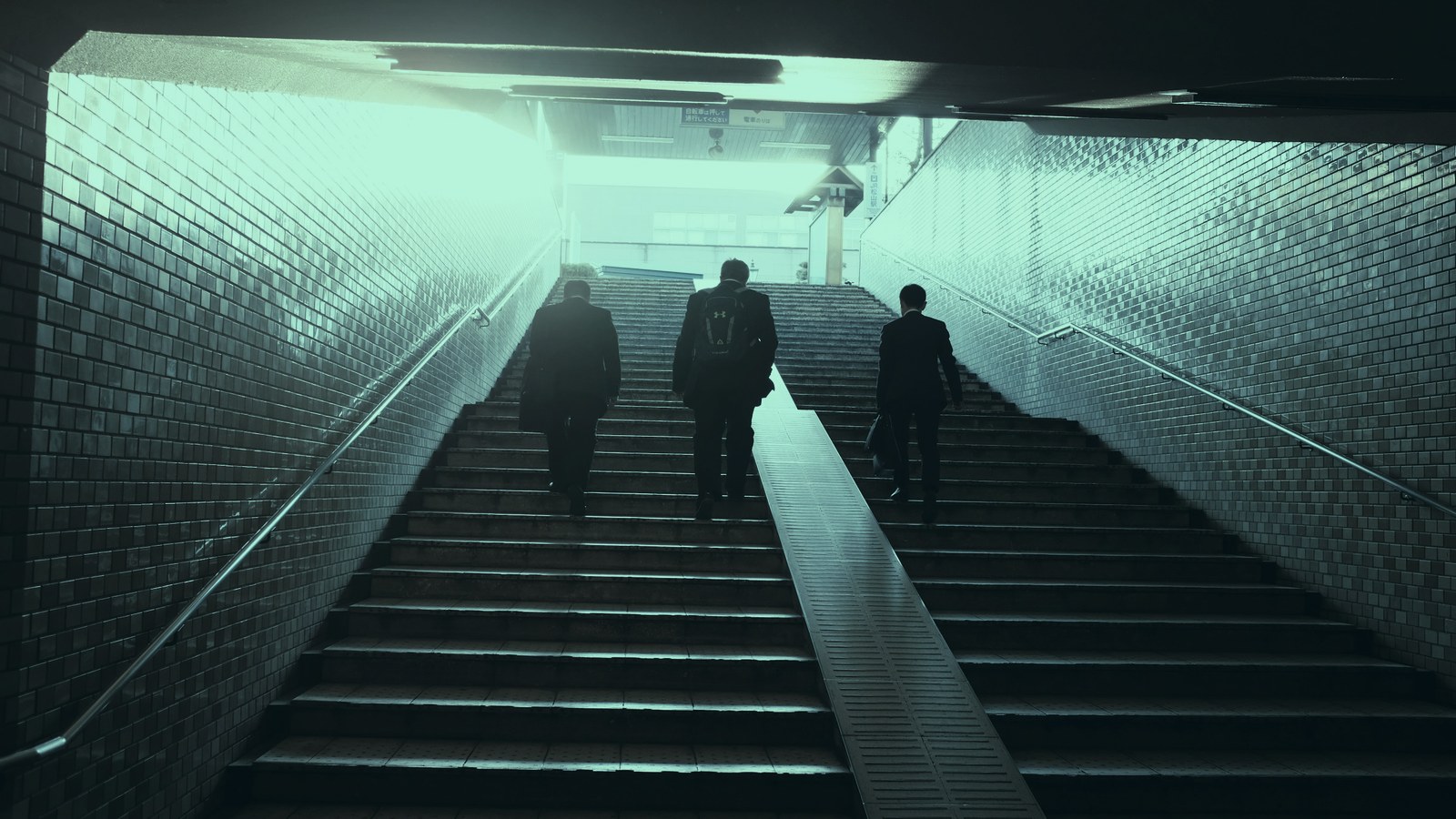 AI leader onboarding cover, three professionals climbing a stairway toward daylight, Axial Search