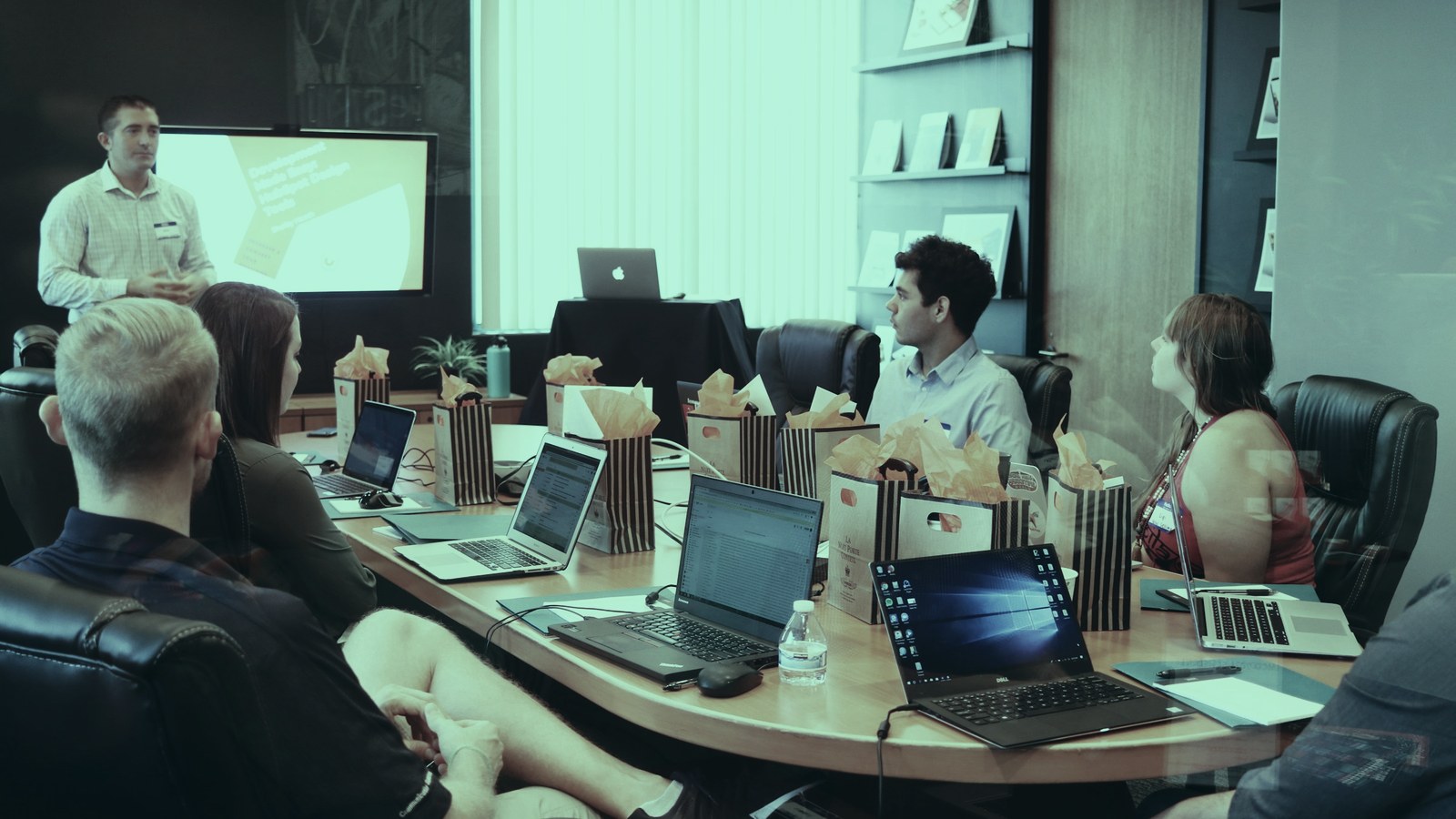 AI steering committee cover, executives reviewing an AI programme around a boardroom table, Axial Search