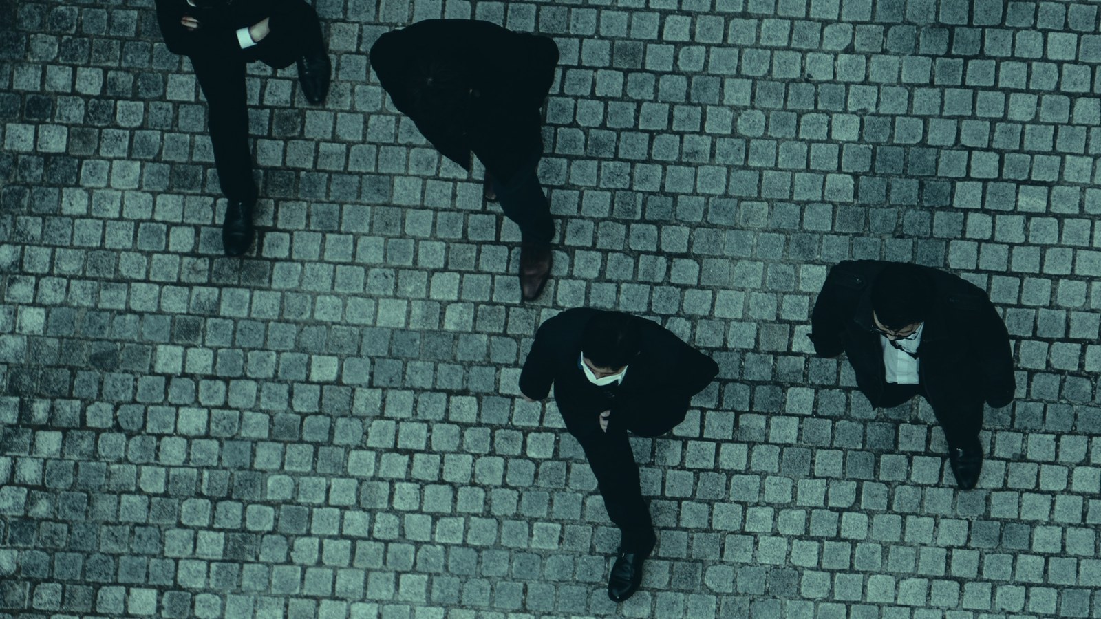 Assess AI candidates cover, four professionals viewed from above on cobbled ground, Axial Search