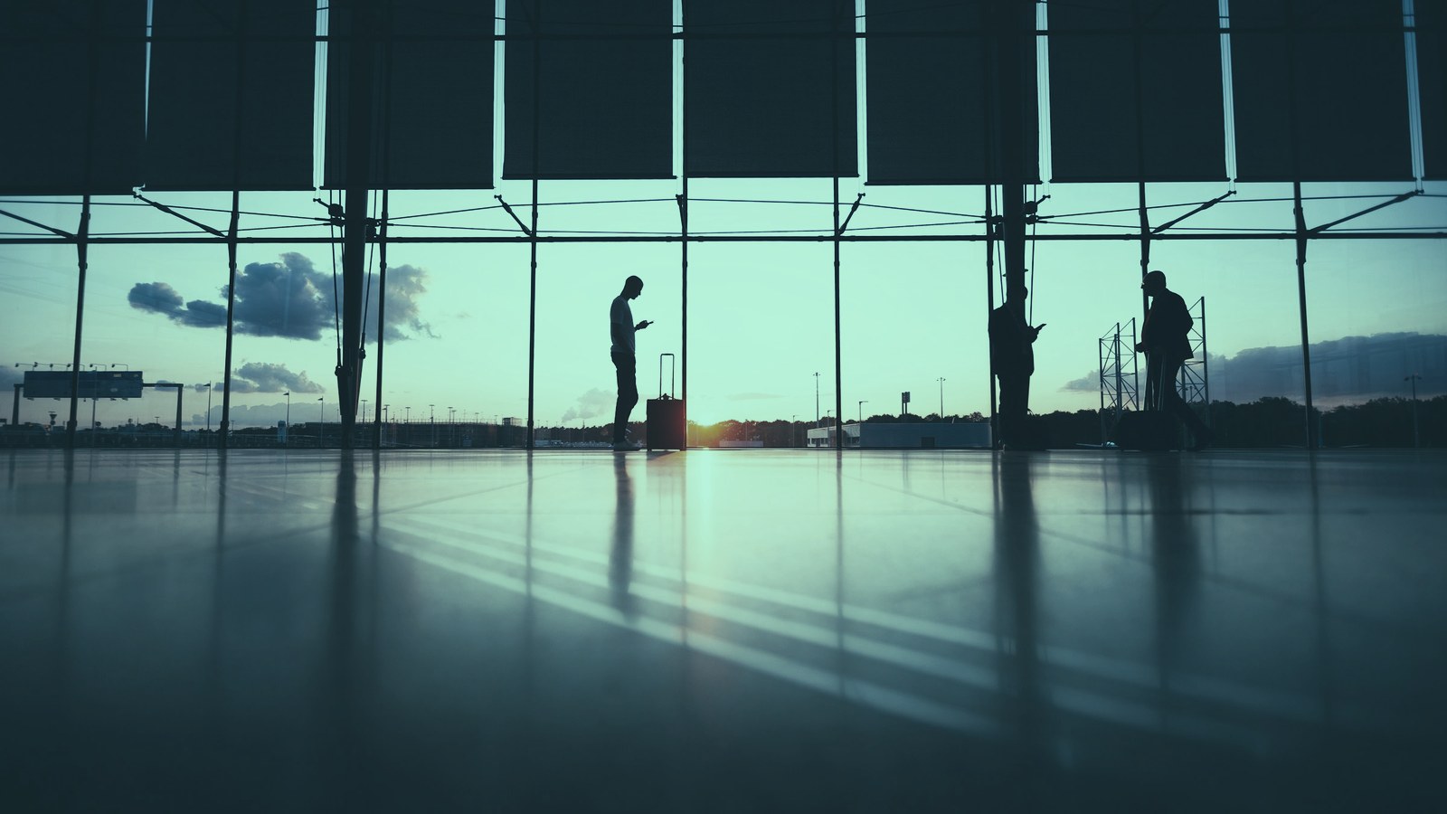 CAIO position cover, a traveller waiting in an airport terminal at sunset, Axial Search