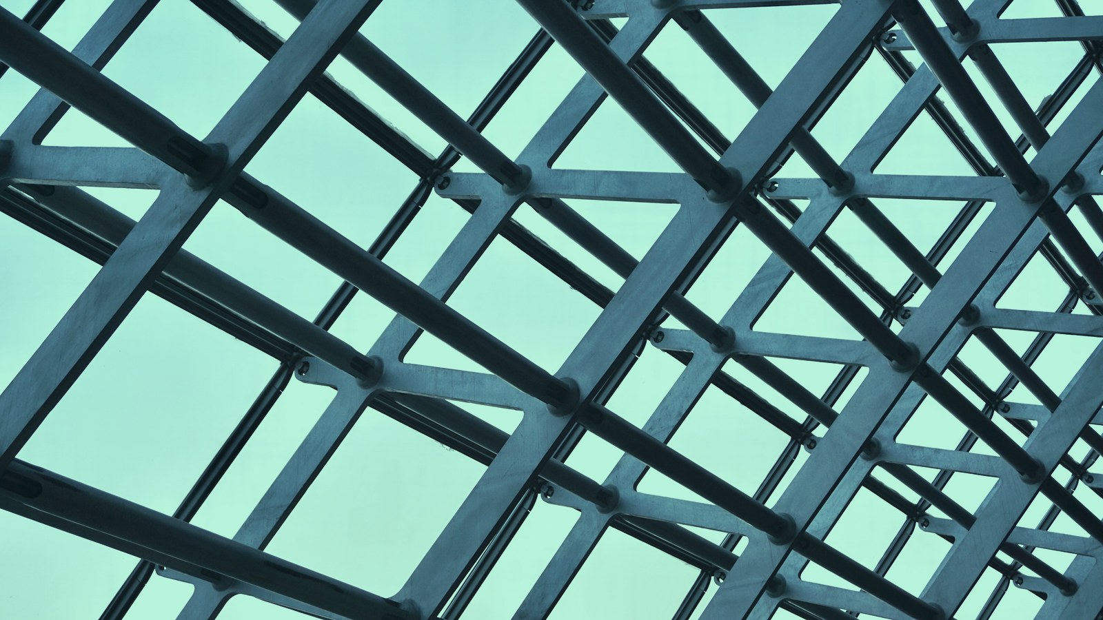 Fractional AI leadership cover, an engineered steel lattice against open sky, Axial Search