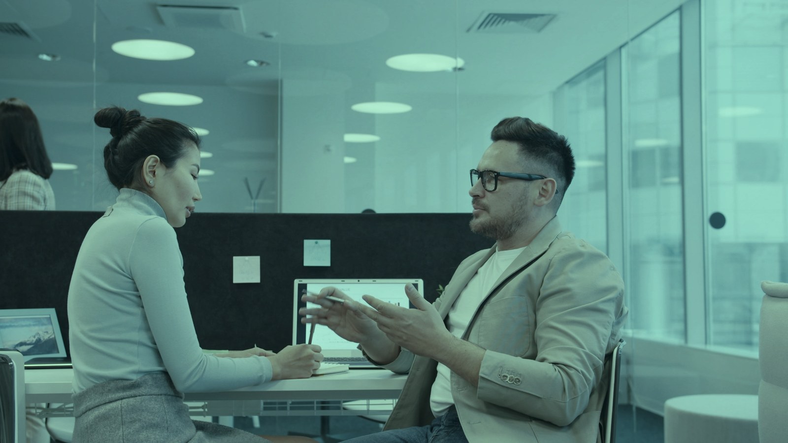 Hire or promote a chief AI officer: a hiring manager talking with a candidate across an office desk