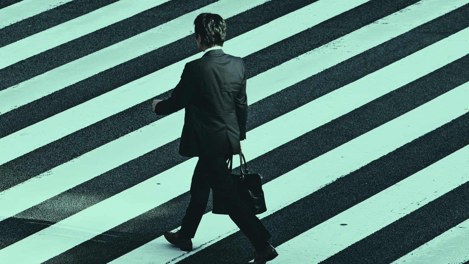 Permanent or fractional AI leader decision cover, businessman crossing a striped crosswalk, Axial Search